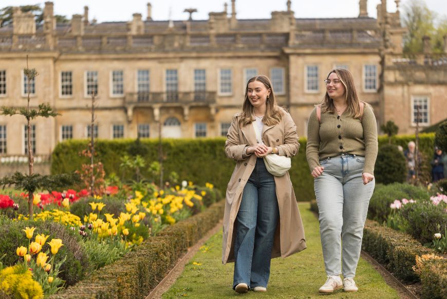two women walking in a garden